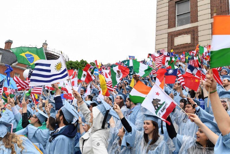 SIPA graduates at Commencement on Low plaza waving the flags of their home countries. 